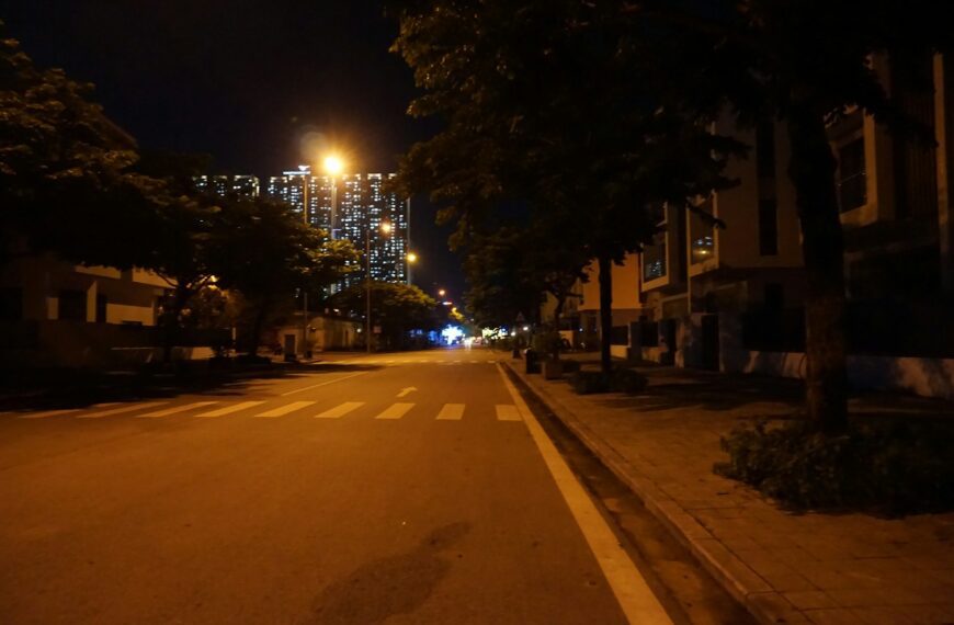 a city street at night with buildings in the background