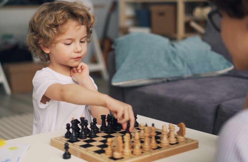 a little boy playing a game of chess