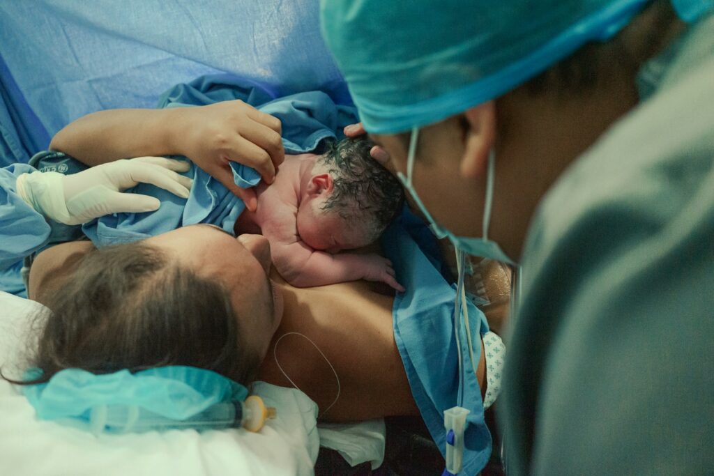 Mother holding newborn baby after birth