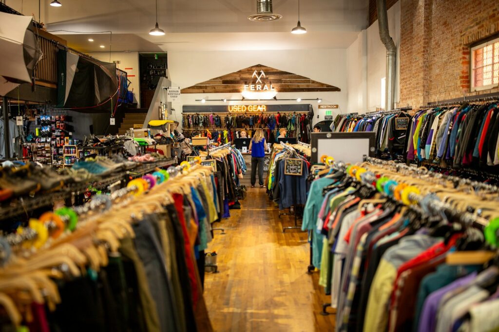 A person stands in a well-stocked outdoor gear store.