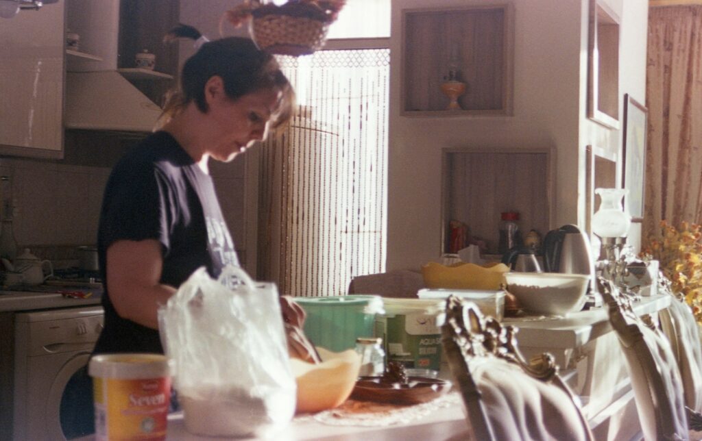 Woman is preparing something in the kitchen.