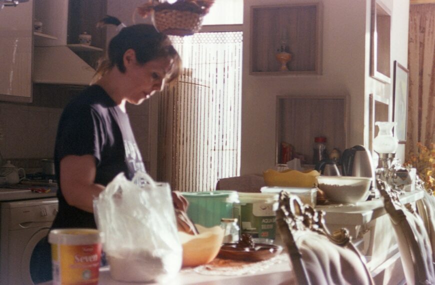 Woman is preparing something in the kitchen.