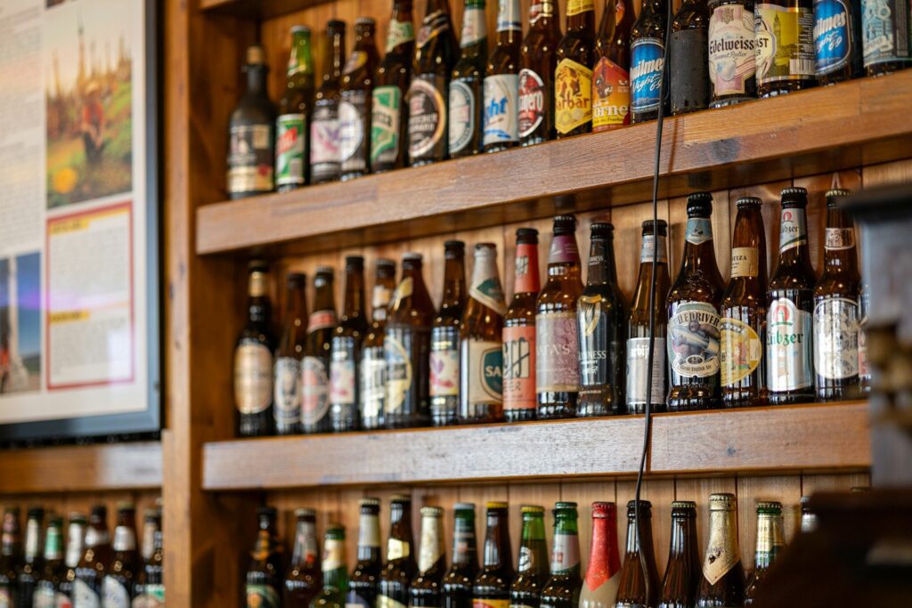 Bottles of beer displayed on wooden shelves.
