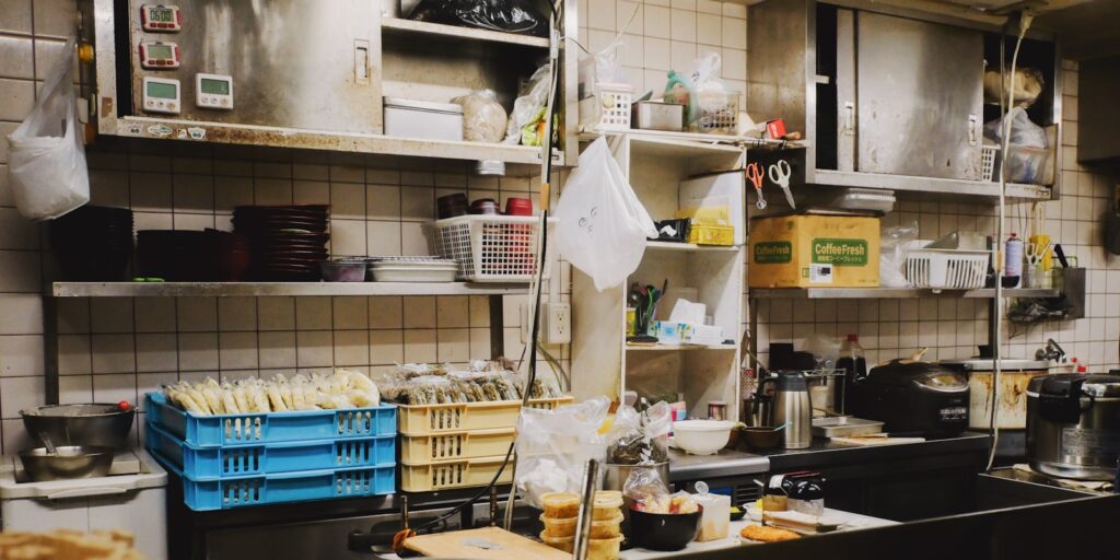 Busy kitchen counter with shelves and containers