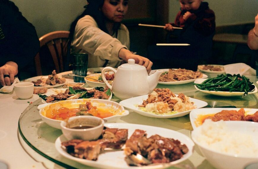 A group of people sitting around a table full of food
