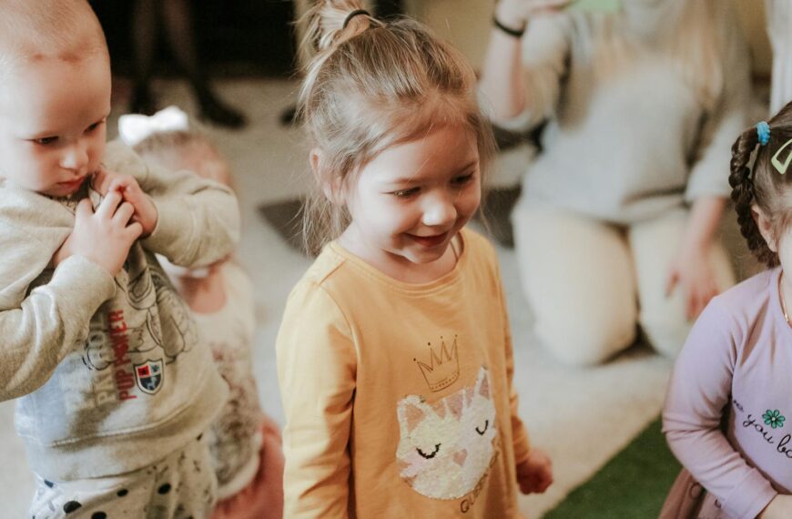 Happy children playing indoors with toys, showcasing joyful interaction and smiles.