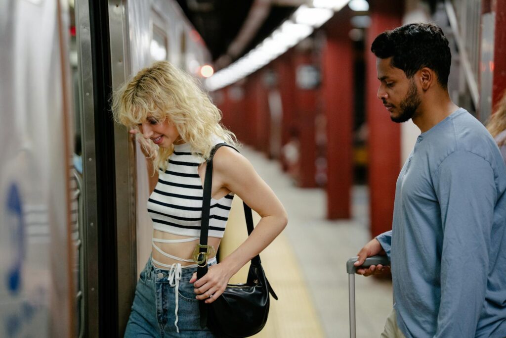 A man and woman board a subway train, showcasing urban transportation and daily commuting.