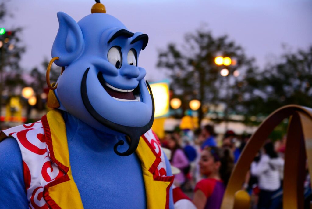 Vibrant Genie costume in an outdoor festival setting with people enjoying lively atmosphere.