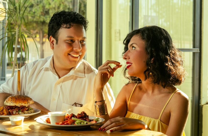 A couple shares food and laughs together.