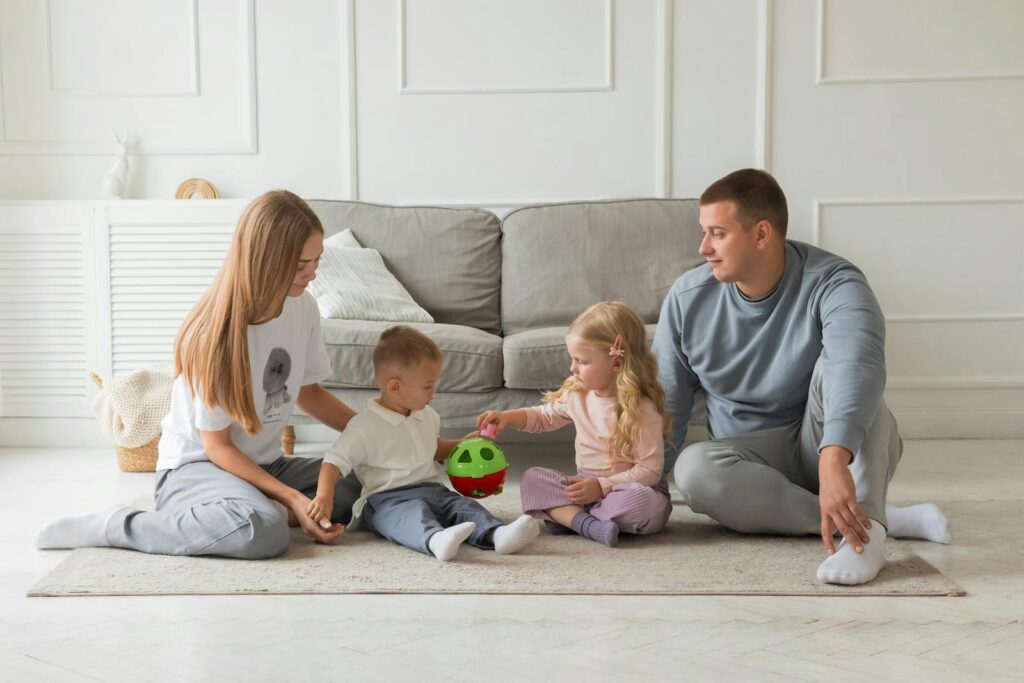 Parents and children enjoying quality time at home, playing with toys in a cozy living room setting.