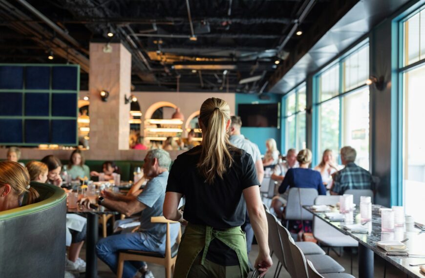 A group of people sitting at tables in a restaurant