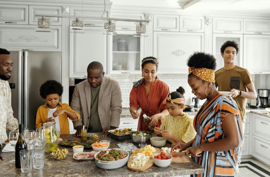 A happy family gathers in the kitchen to prepare a delicious meal together, fostering togetherness and joy.