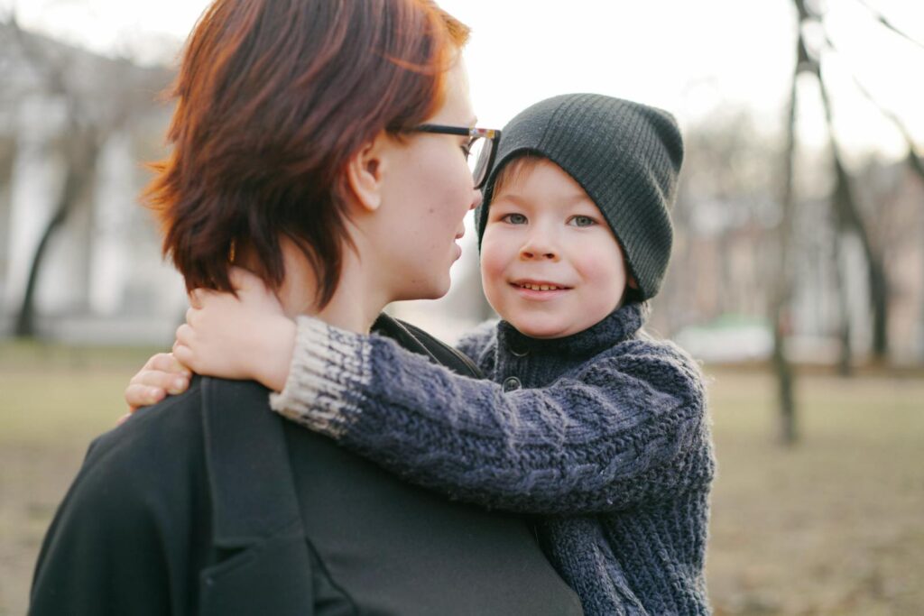 A heartwarming moment between a mother and child enjoying a day in the park.