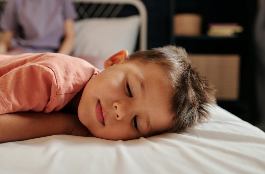A young child sleeping peacefully in a cozy bedroom setting, embodying tranquility and rest.