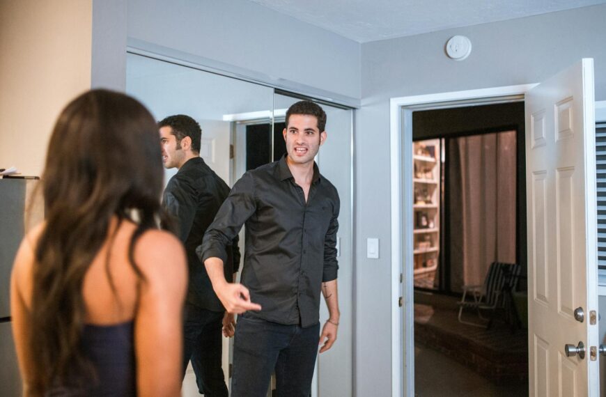 A couple having an intense discussion in a contemporary living room setting with reflections.