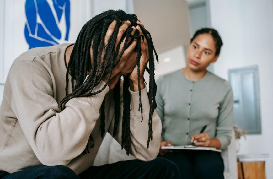A young couple in a serious indoor discussion, dealing with relationship issues and emotions.