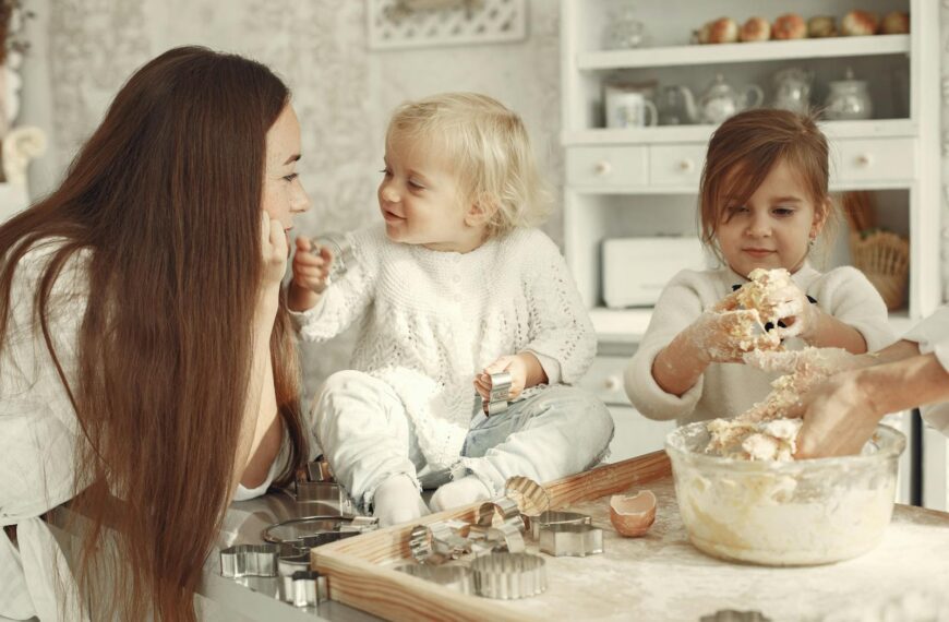 Happy family bonding while baking cookies in a cozy kitchen setting.