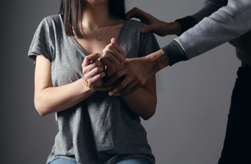 woman in gray scoop neck shirt holding her hands