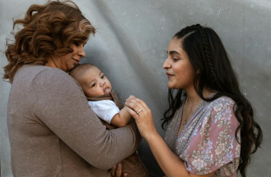 Warm family interaction with a mother and her baby, captured indoors, showcasing happiness and love.