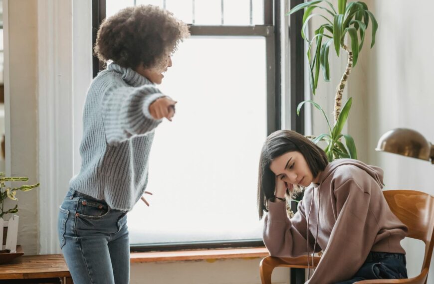 Two women having an intense emotional conversation indoors, involving expressions of frustration.