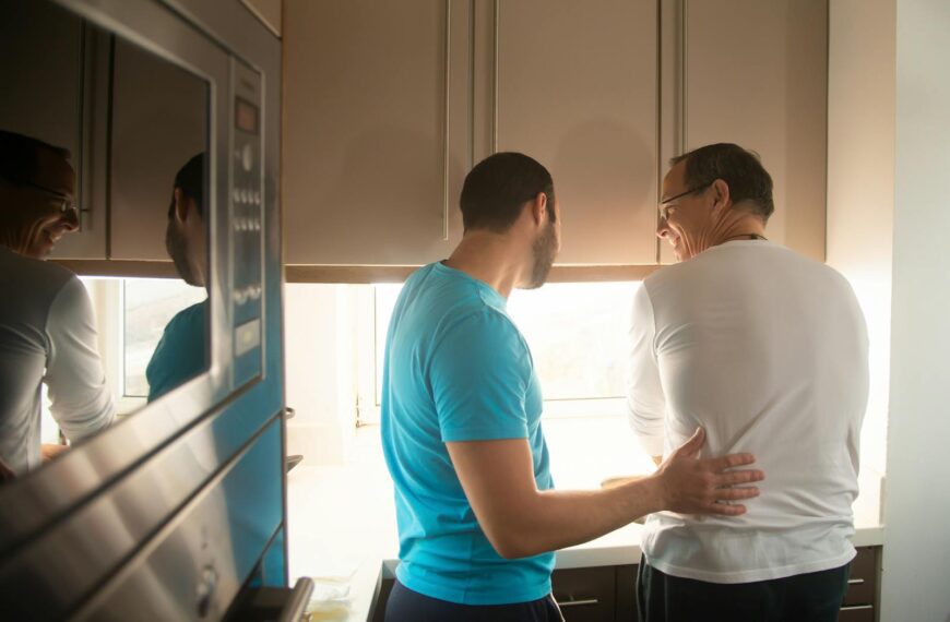 Two men enjoy cooking together in a bright kitchen, reflecting love and togetherness.