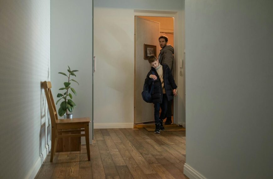 Father and son entering their cozy apartment, highlighting family togetherness and home comfort.