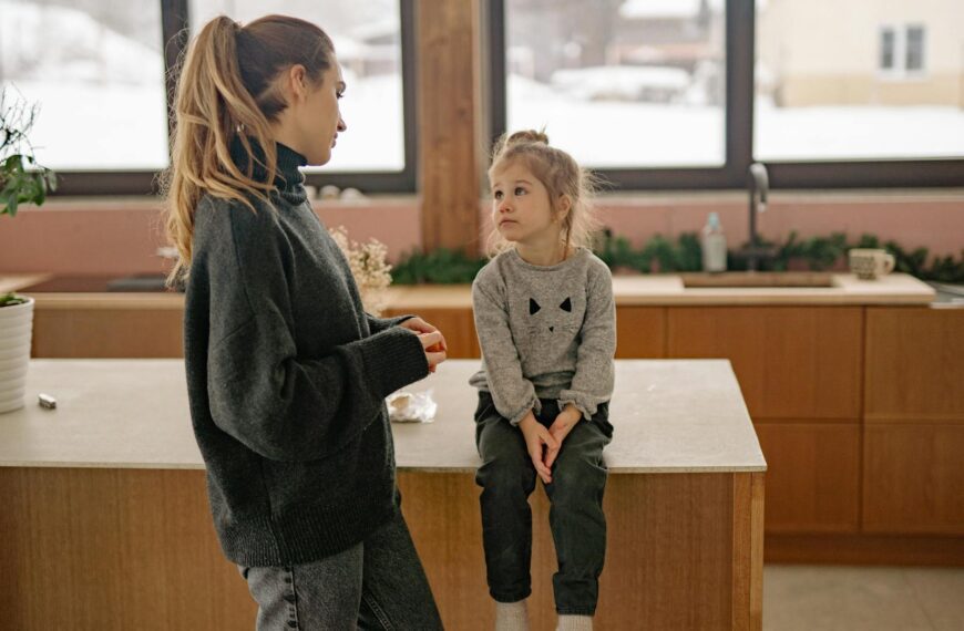 Family scene with mother and daughter in a warm, cozy kitchen setting.