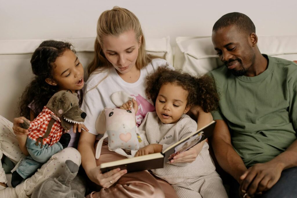 A diverse family enjoys reading a storybook together, fostering warmth and connection.