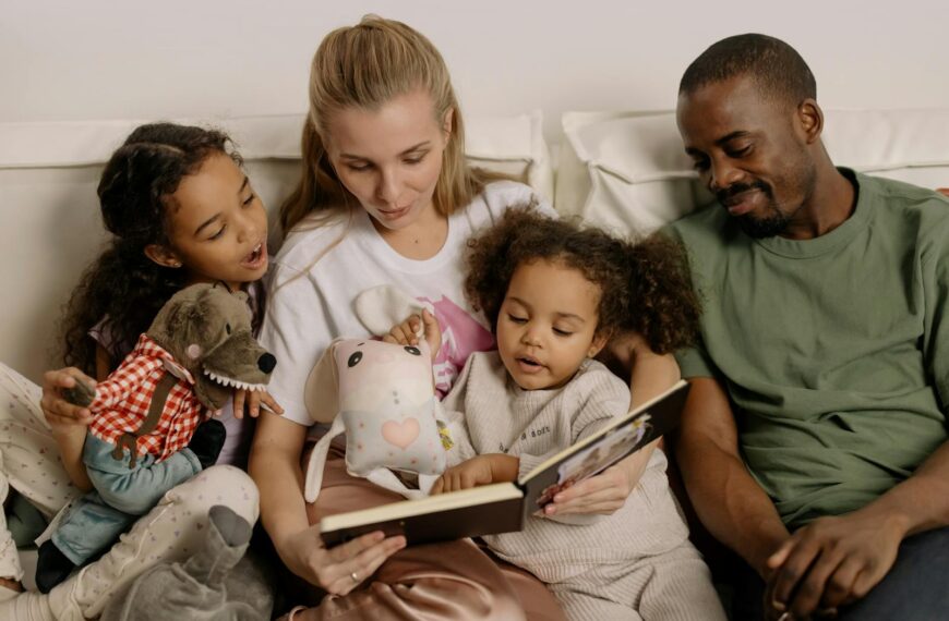 A diverse family enjoys reading a storybook together, fostering warmth and connection.