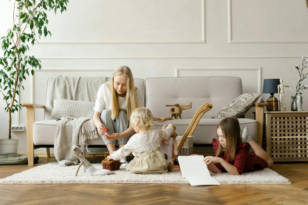 A family enjoying quality time with toys and books in a stylish living room.