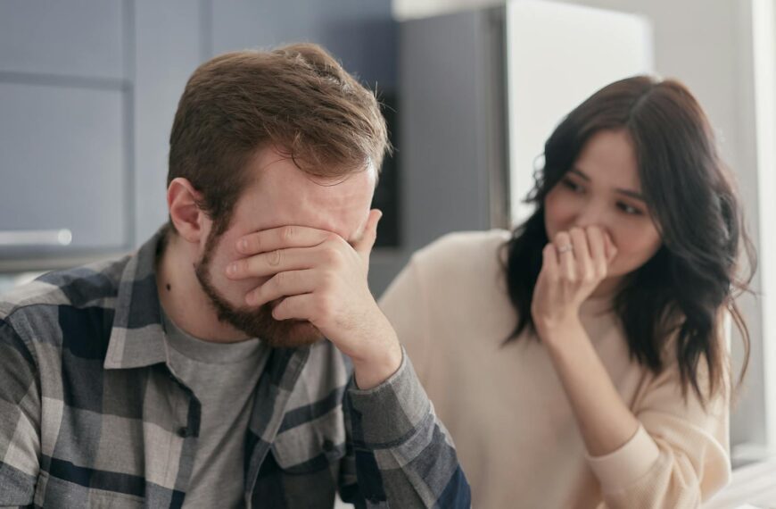 A distraught couple indoors, showing stress and concern, fostering empathy.
