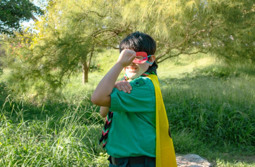 a boy in a green shirt and yellow scarf