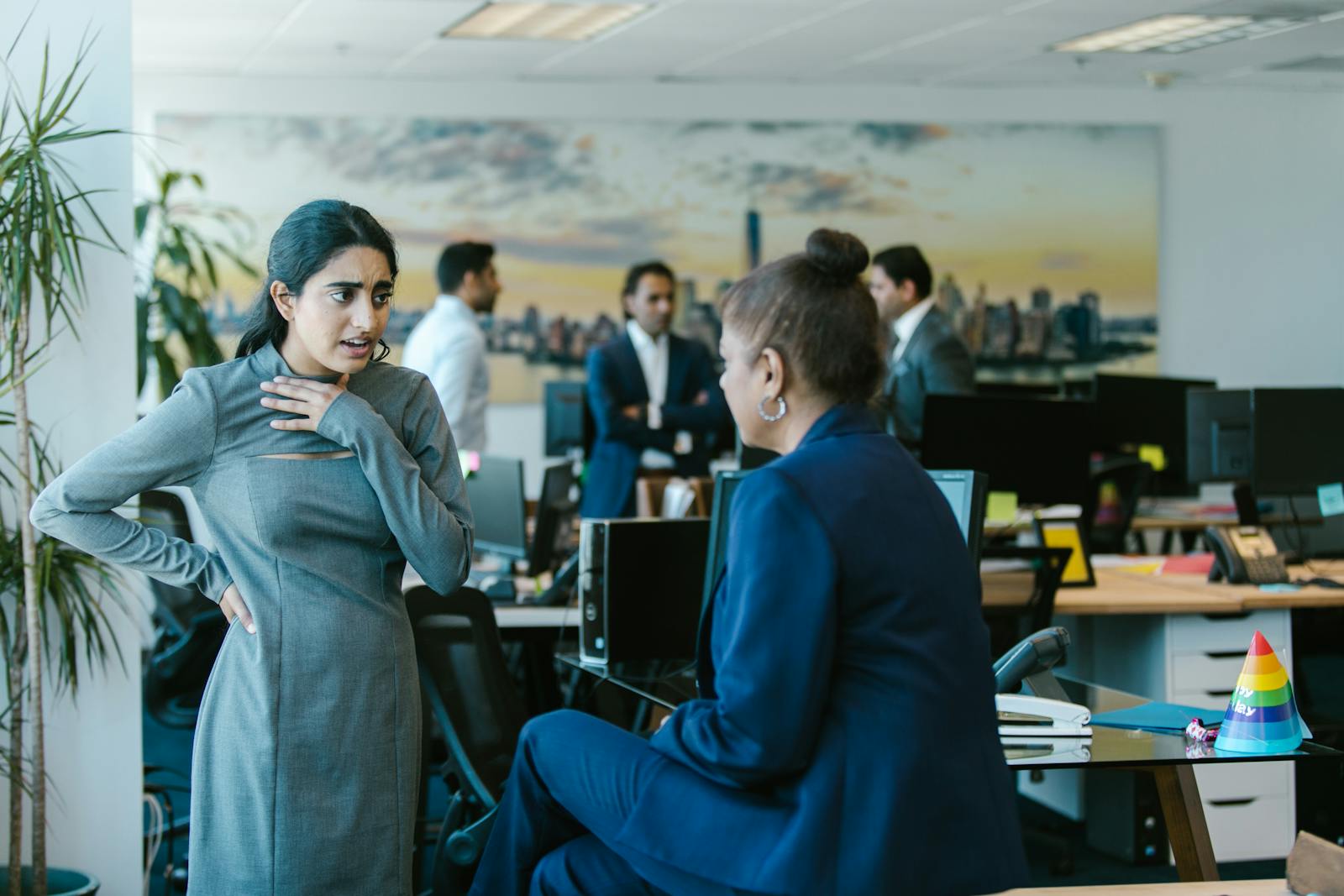 Employees engage in a lively discussion in a contemporary office setting.