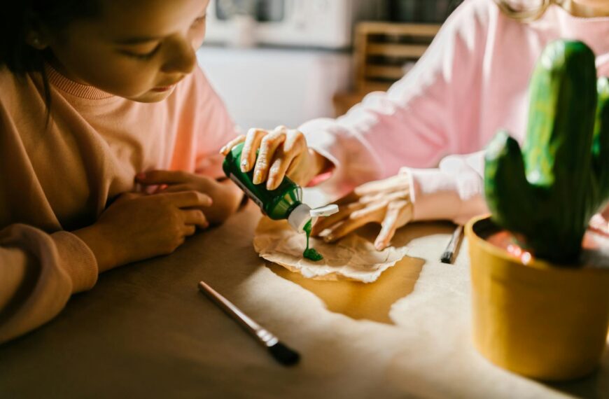 Children enjoying a crafting project indoors with paint and creativity.