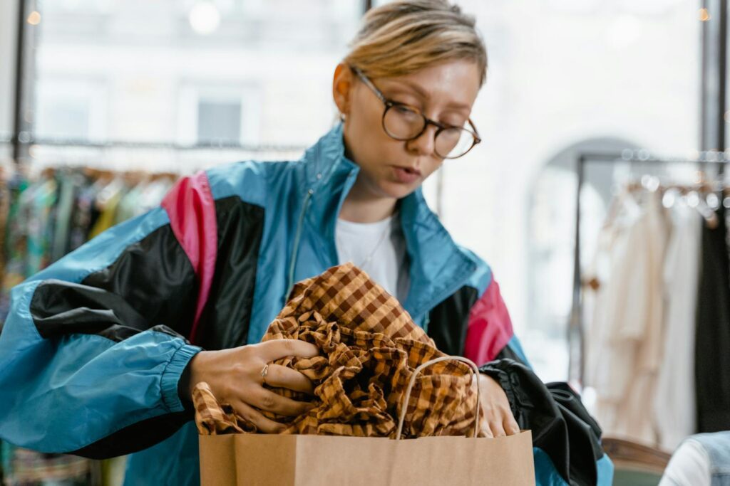 Caucasian woman in a colorful jacket shopping in a trendy boutique.