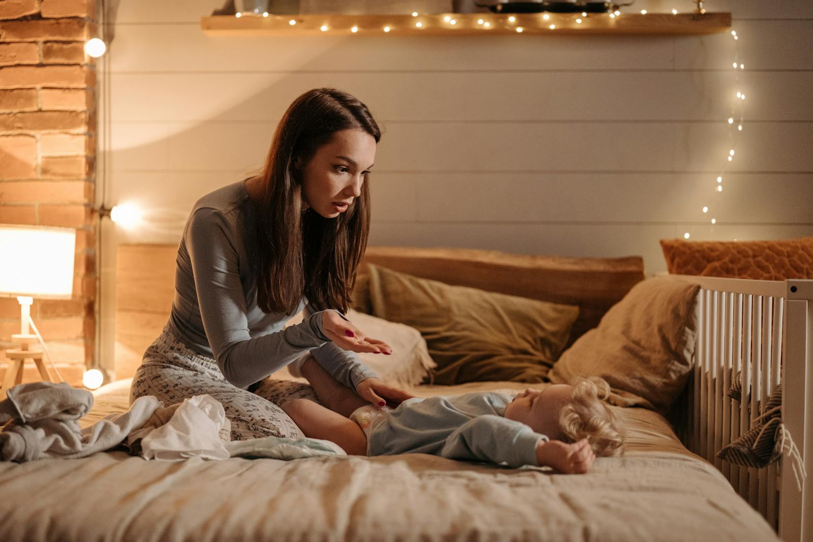 A mother and son enjoying bedtime together indoors with soft lighting and fairytale ambiance.