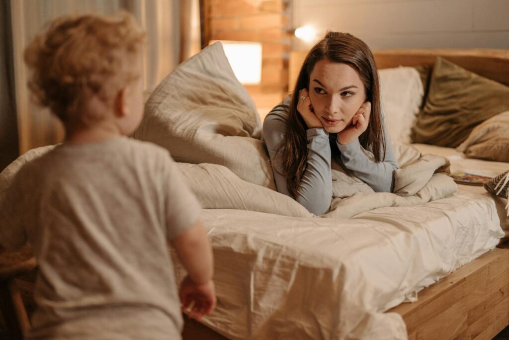 Warm bedtime moment with mother and child in cozy room lighting.