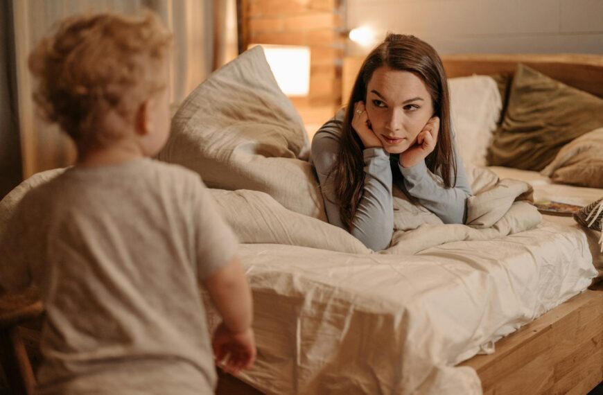 Warm bedtime moment with mother and child in cozy room lighting.