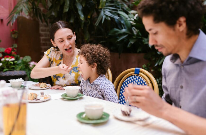 Family dining outdoors with focus on bonding and togetherness while enjoying a meal.