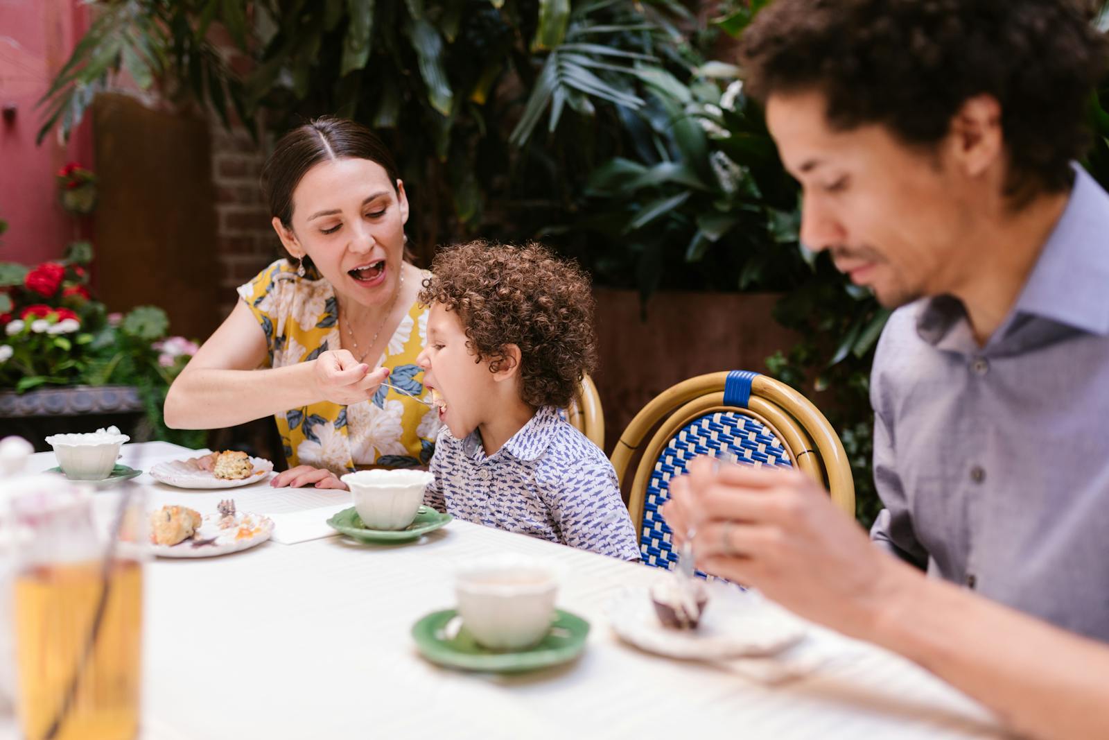 Family dining outdoors with focus on bonding and togetherness while enjoying a meal.