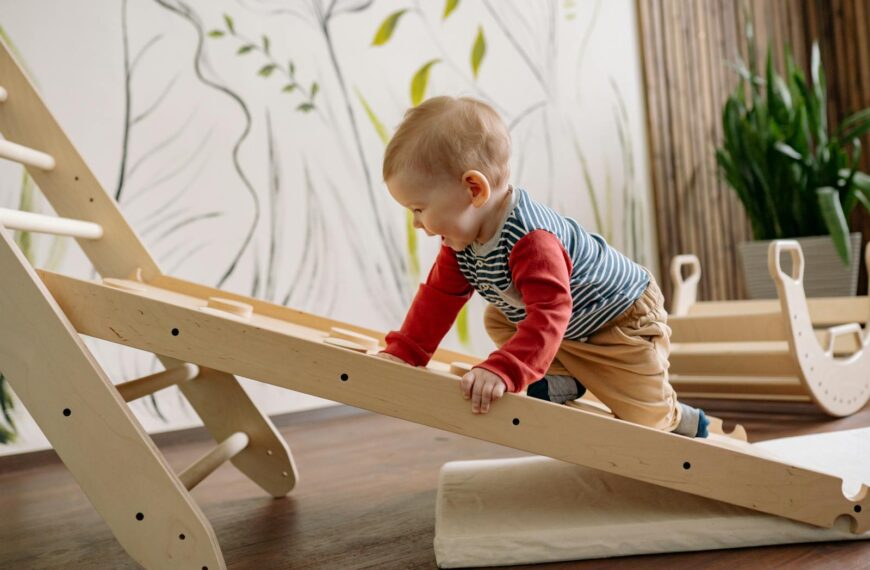 A young child enjoys climbing a wooden toy ladder indoors, promoting playtime and activity.