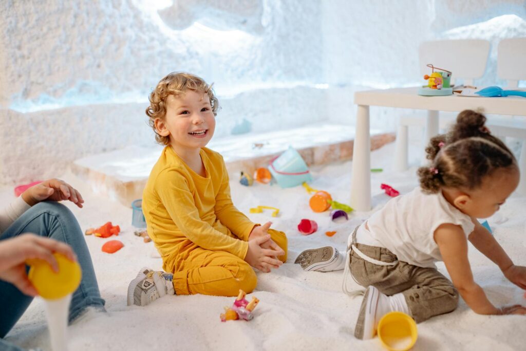 Children enjoying playful activities indoors, showcasing joy and creativity.