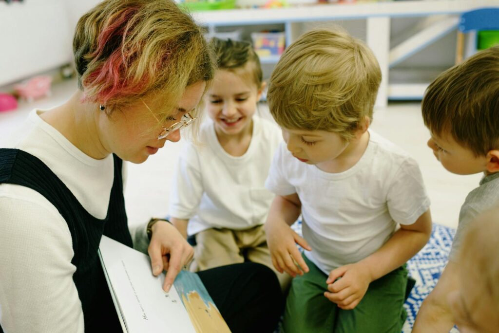 Teacher reading to children in a lively kindergarten classroom setting.