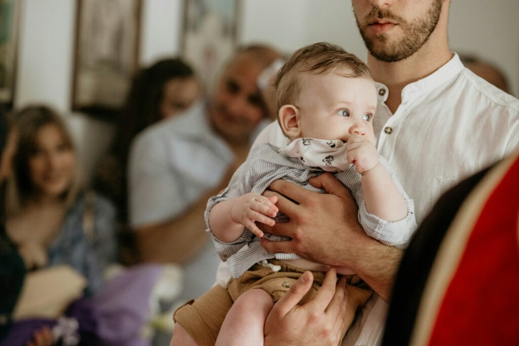 a man holding a baby in his arms