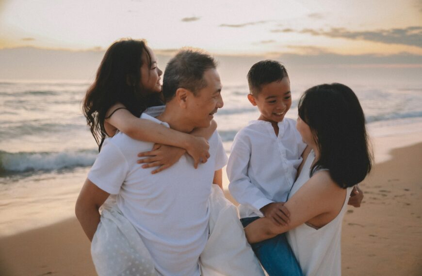 Family enjoying a beach walk at sunset