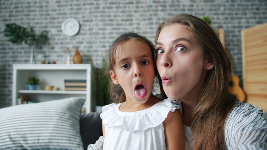 Mother and daughter making funny faces together