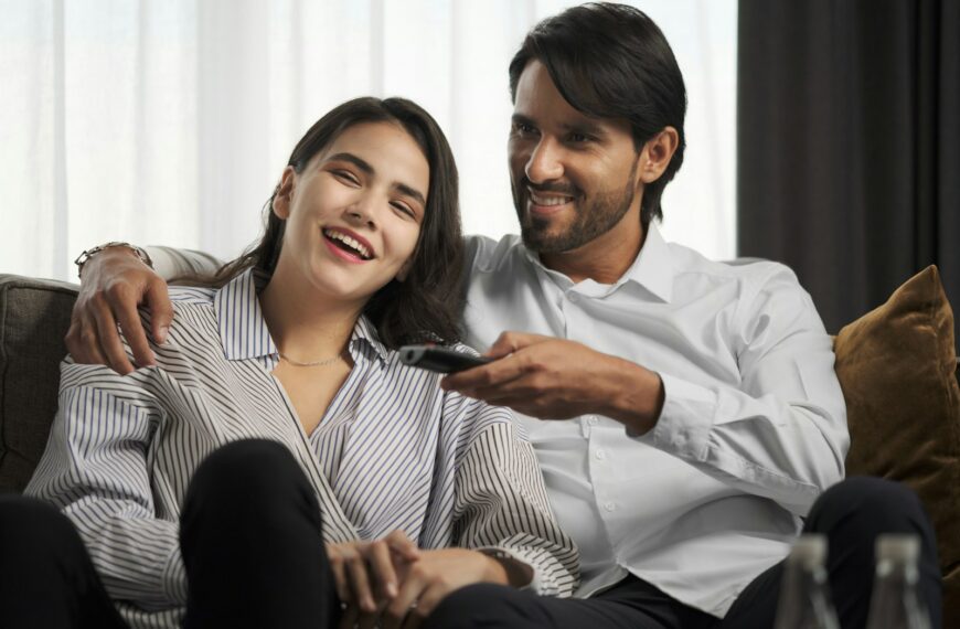 a man sitting next to a woman on a couch