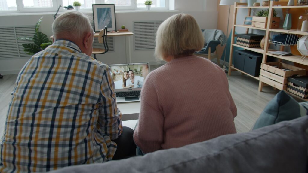 Elderly couple watching a video on laptop at laptop.