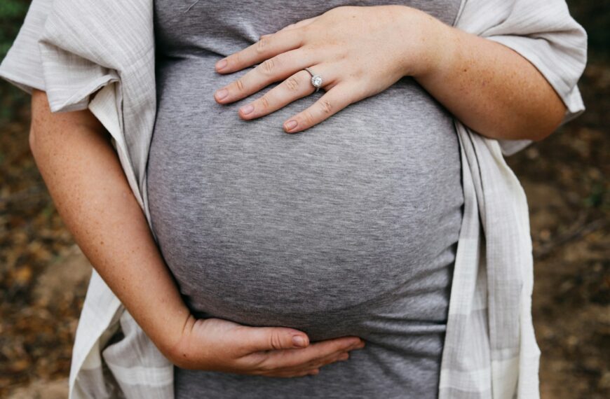 a pregnant woman holding her belly in her hands