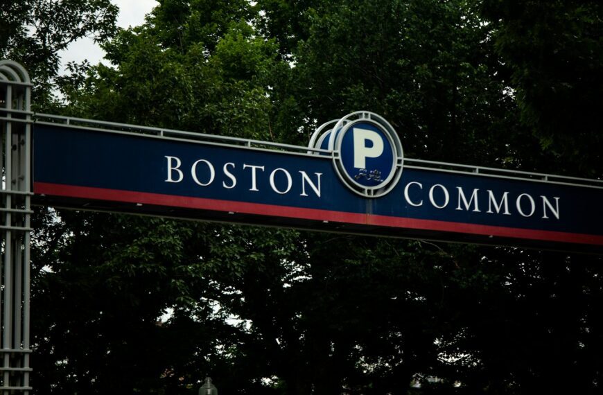 a street sign for boston common with trees in the background